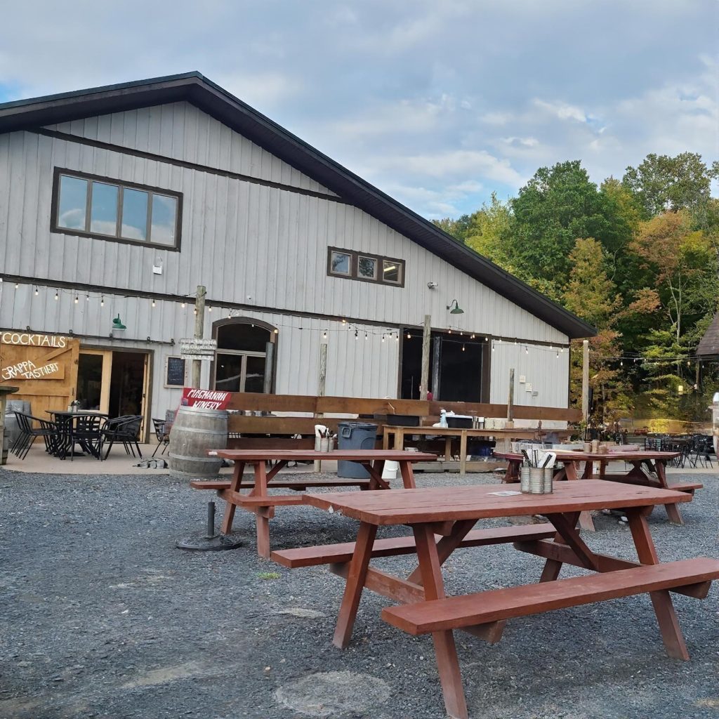Outdoor tables at Magnanini Winery in the Hudson Valley during a chauffeured wine tasting tour from Westchester County.