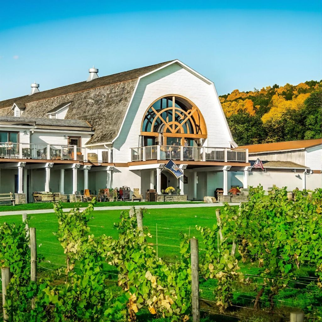 View of the winery house at Millbrook Vineyards from the vineyard during a chauffeured wine tasting tour from Westchester County.
